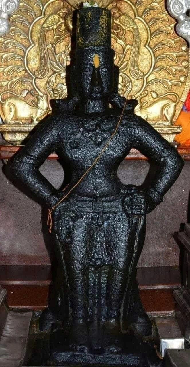 Sacred black stone deity sculpture restored with Vajralep